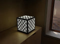 300mm metal cube lamp featuring a circle mosaic cut-out pattern, white plexiglass panels, and a textured black finish.