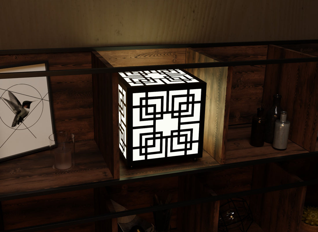 300mm metal cube lamp featuring a Greek key cut-out pattern, white plexiglass panels, and a textured black finish.