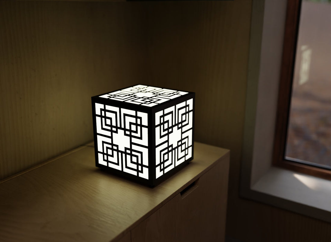 300mm metal cube lamp featuring a Greek key cut-out pattern, white plexiglass panels, and a textured black finish.