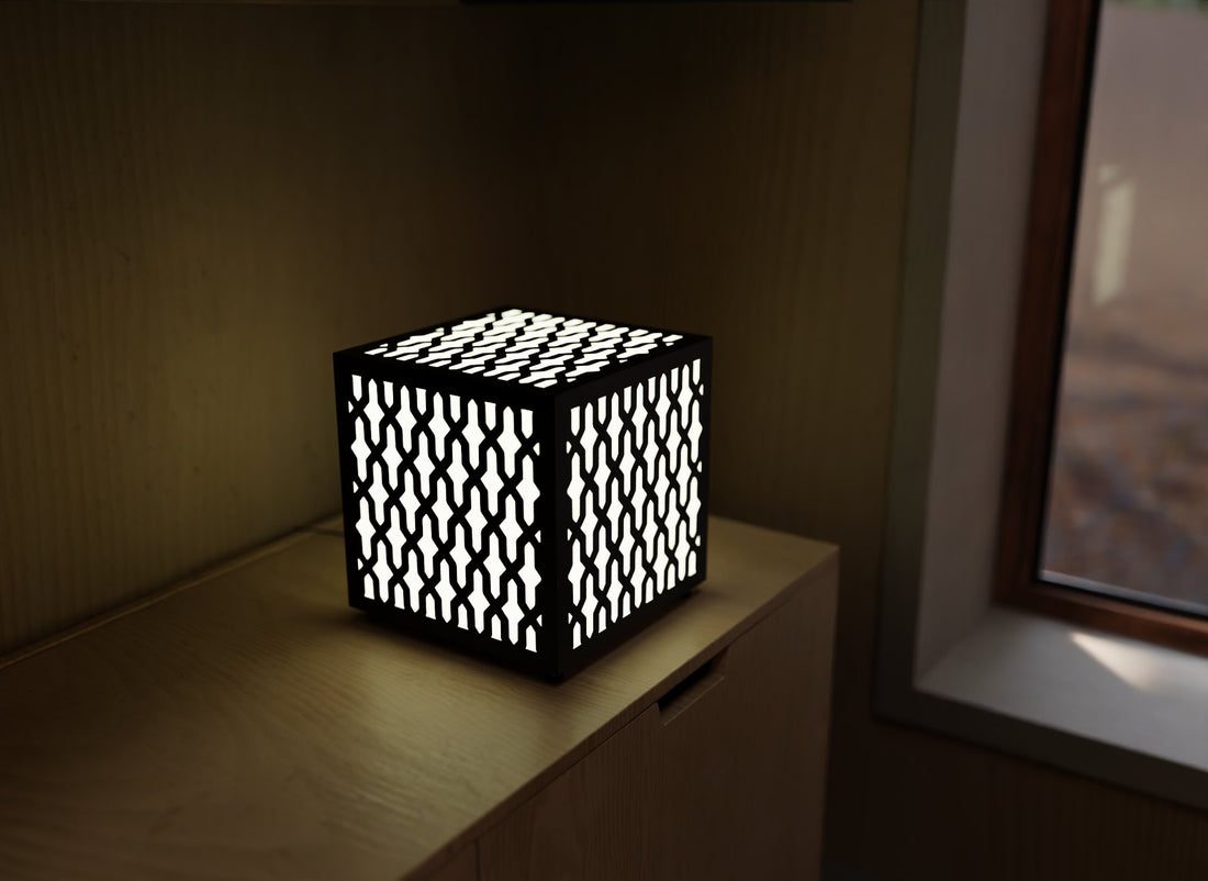 300mm metal cube lamp featuring an interlocking cut-out pattern, white plexiglass panels, and a textured black finish.