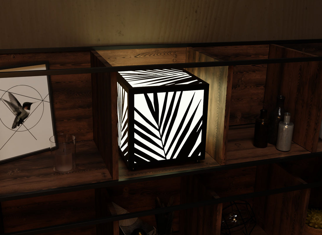 300mm metal cube lamp featuring a palm shadow grid cut-out pattern, white plexiglass panels, and a textured black finish.