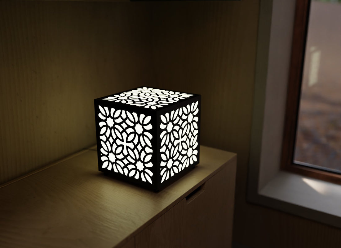 300mm metal cube lamp featuring a petal lace grid cut-out pattern, white plexiglass panels, and a textured black finish.