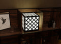 300mm metal cube lamp featuring a cross lattice cut-out pattern, white plexiglass panels, and a textured black finish.