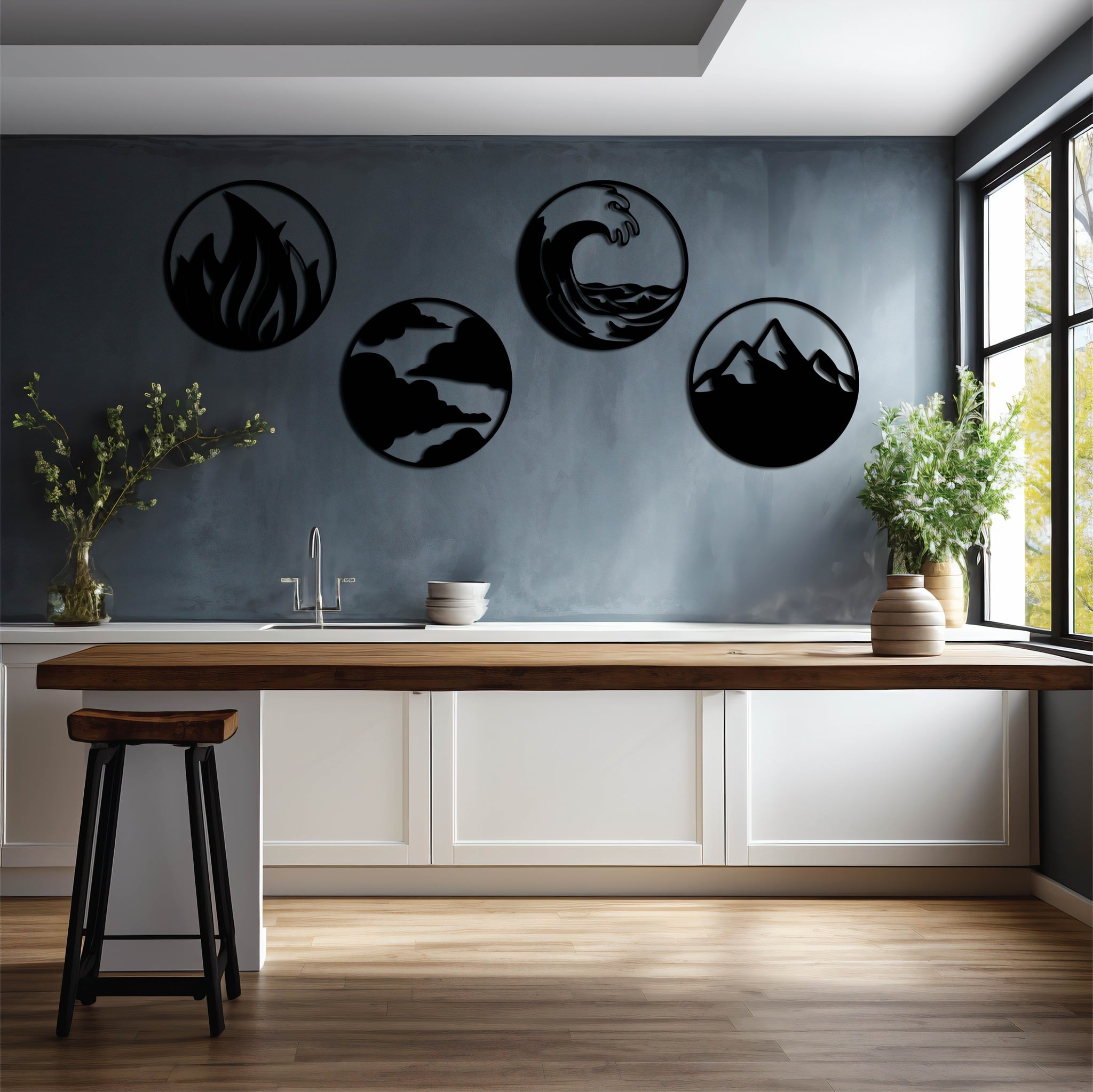 Set of four circular metal wall art pieces representing the elements of fire, water, air, and earth, displayed on a modern kitchen wall with a minimalist aesthetic.