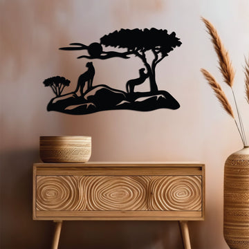 Wide metal wall art depicting two leopard relaxing in the vivid sunset in the background, adding elegance to a warm-toned room.