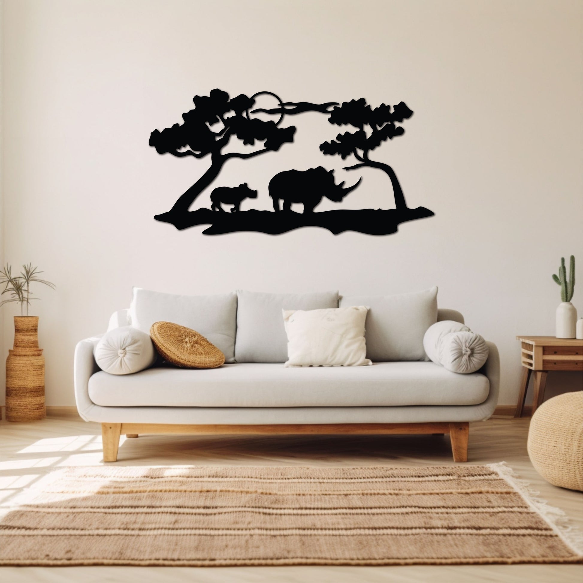 Wide metal wall art depicting two rhinos walking while the sun sets in the background, adding elegance to a warm-toned room.