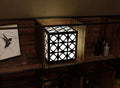 300mm metal cube lamp featuring an orb grid cut-out pattern, white plexiglass panels, and a textured black finish. 