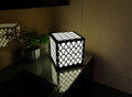 300mm metal cube lamp featuring a raindrop cut-out pattern, white plexiglass panels, and a textured black finish.